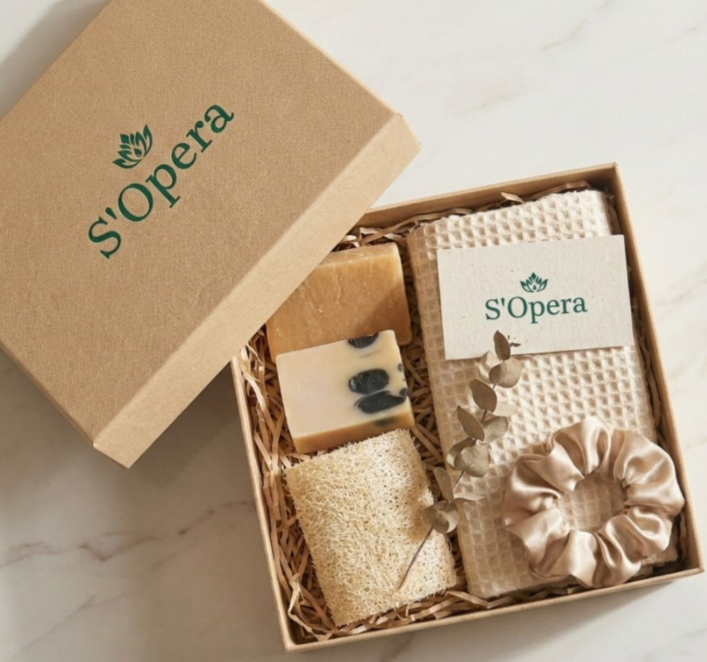 S'Opera gift set with soap, towel, and scrunchie in a box on a marble surface