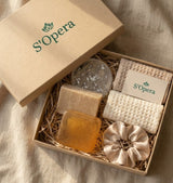 S'Opera soap set with soaps and a scrunchie in a box on a beige fabric background